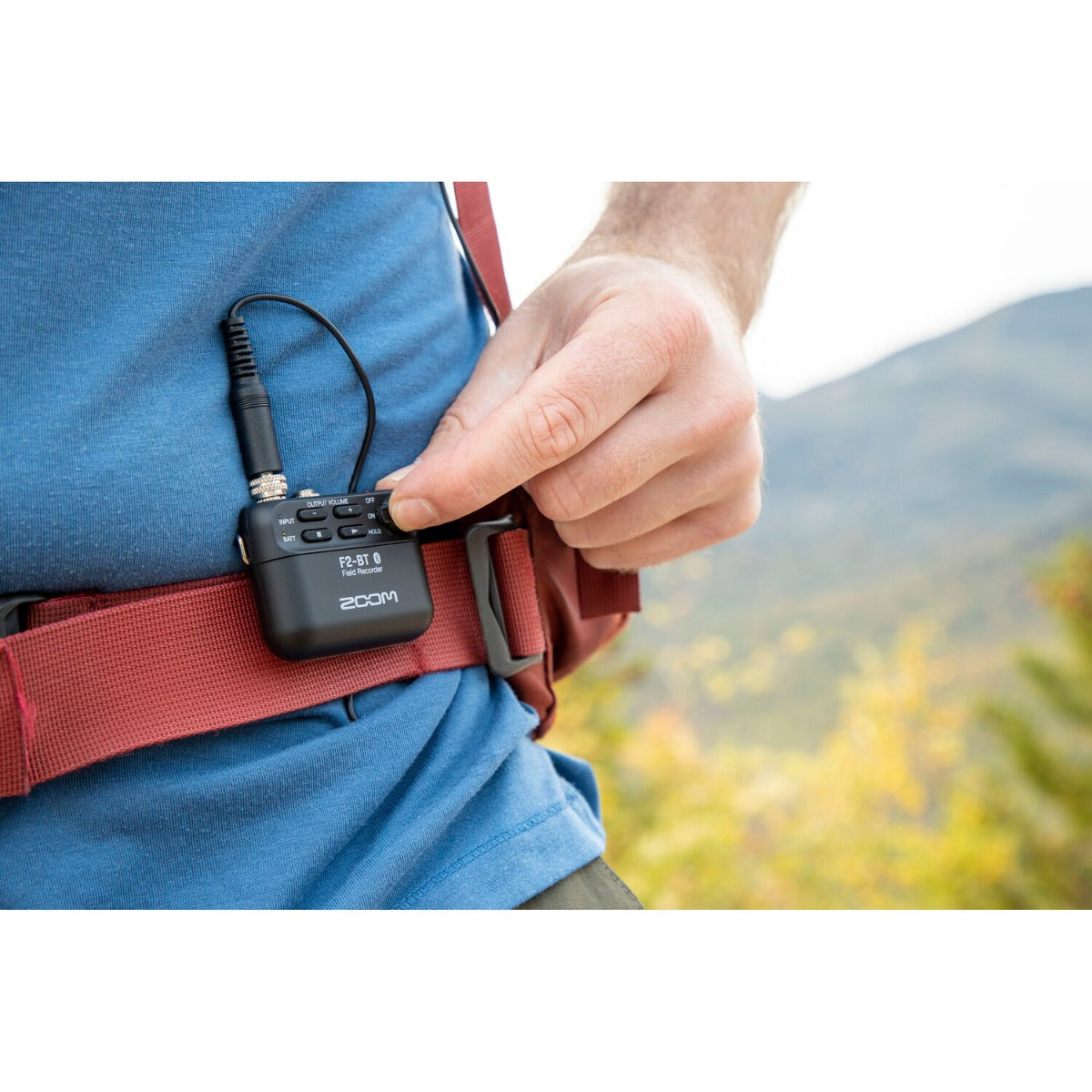 Zoom F2 digital recorder with compact design, featuring multiple input options and a built-in microphone for high-quality audio recording.