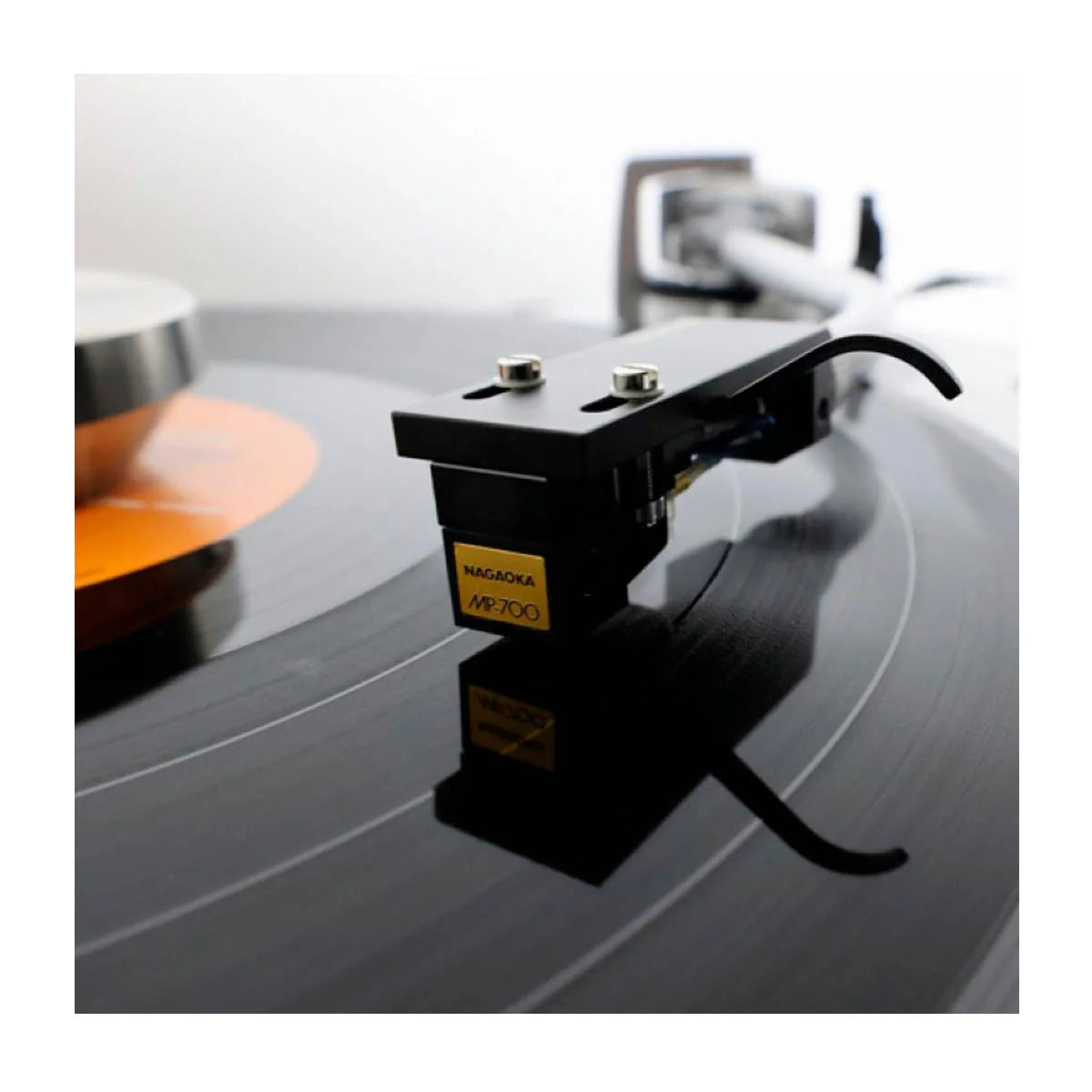 Nagaoka JN-P700 stylus for turntable record player, shown with its sleek design and cartridge tip on a stereo audio setup.