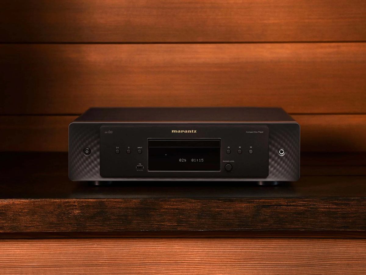 Marantz CD 60 black CD player with sleek design, showing top view and front display on a studio surface.
