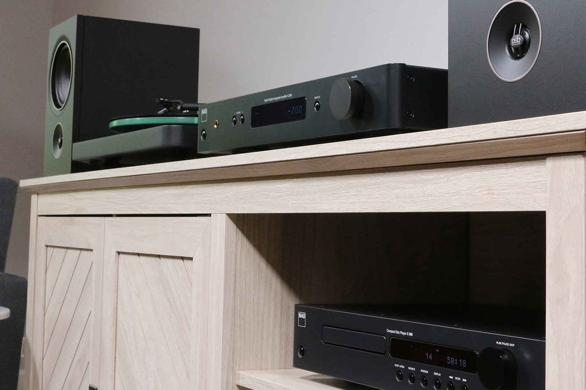 NAD C 338 stereo amplifier installed with front panel controls and connections visible in a home audio setup.