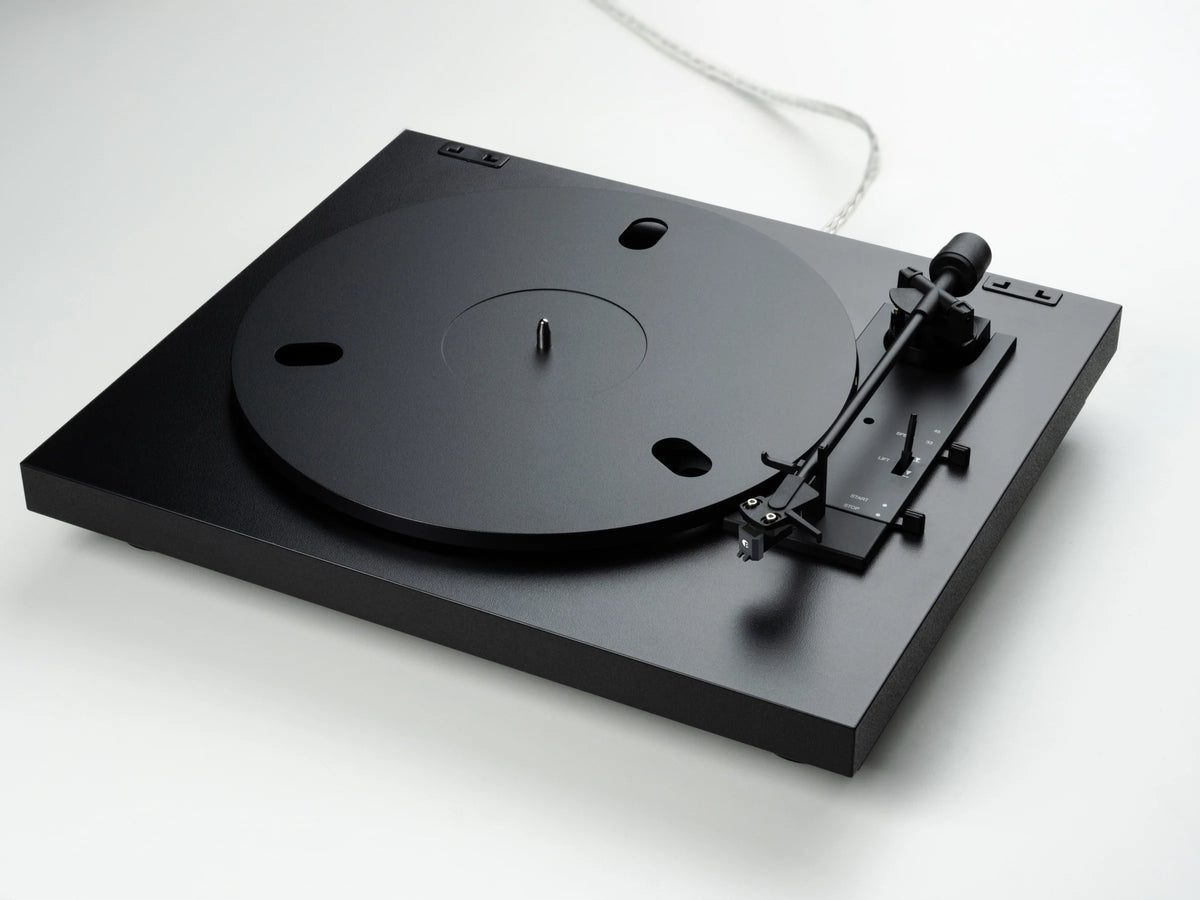 Pro-Ject Automat A1.2 turntable in black, featuring a sleek design with a tonearm and platter visible from a diagonal angle.