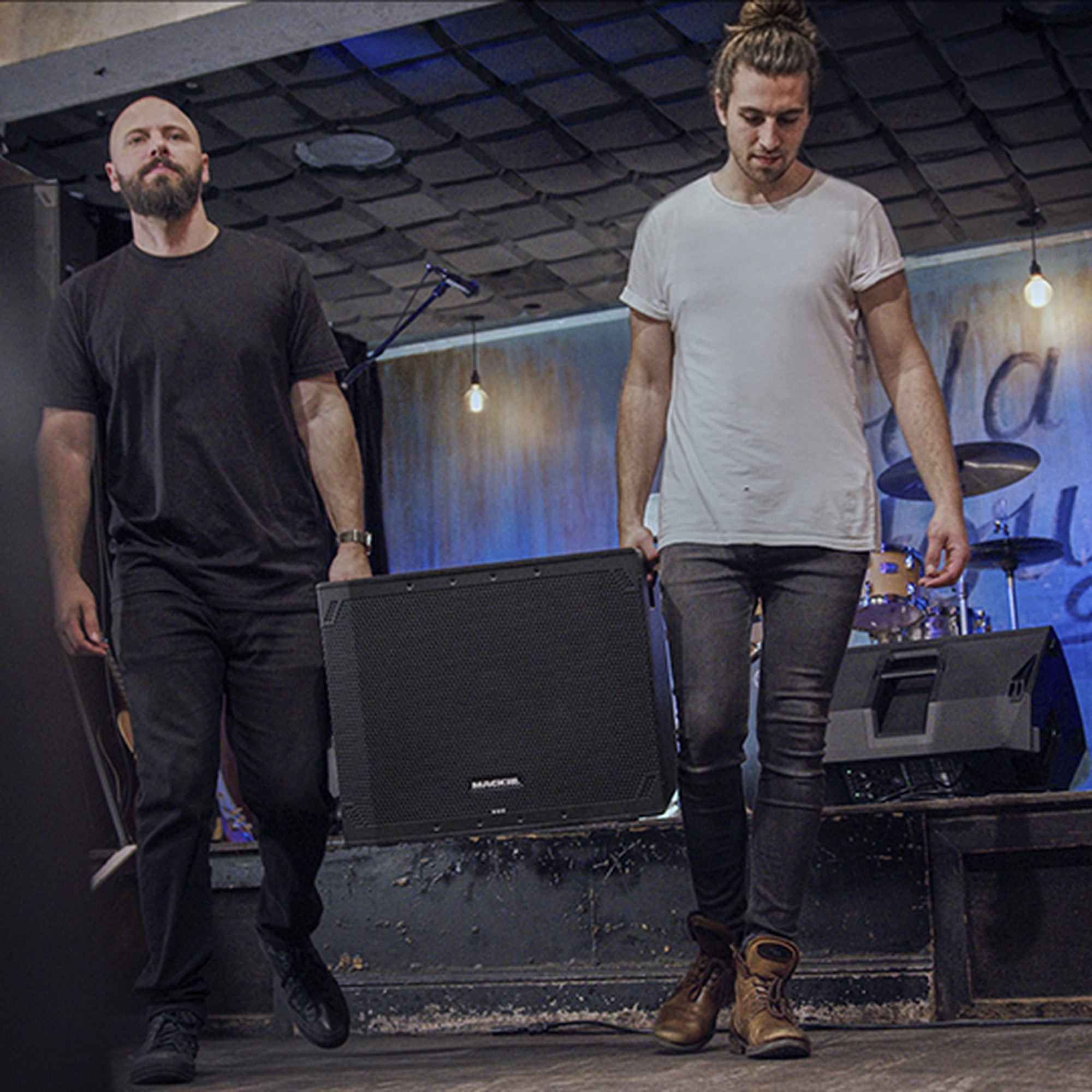 Mackie Thump18SV4 active subwoofer with carry handle, featuring black enclosure and control panel on top.